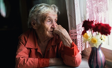 A sad woman looking out the window