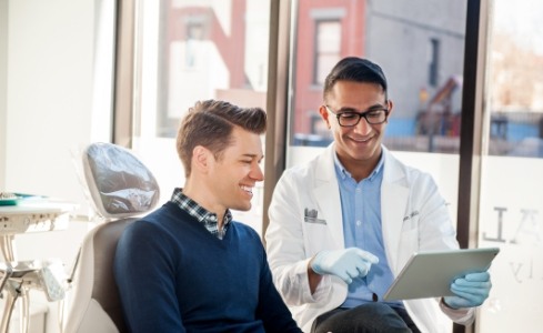 Dentist and patient discussing the cost of dental emergencies