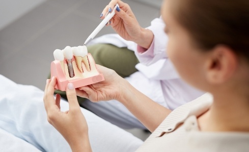 Dentist and patient discussing the benefits of dental implants