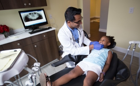 Dentist providing first pediatric dentistry treatment
