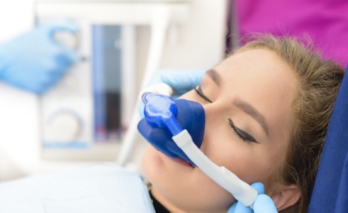 Woman receiving nitrous oxide sedation dentistry treatment