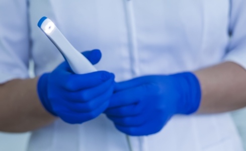 Dentist holding intraoral camera