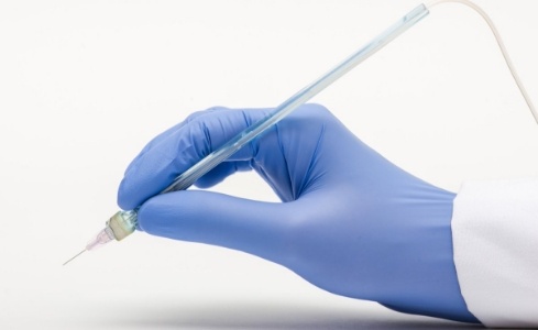 Hand holding the Wand dental anesthesia tool