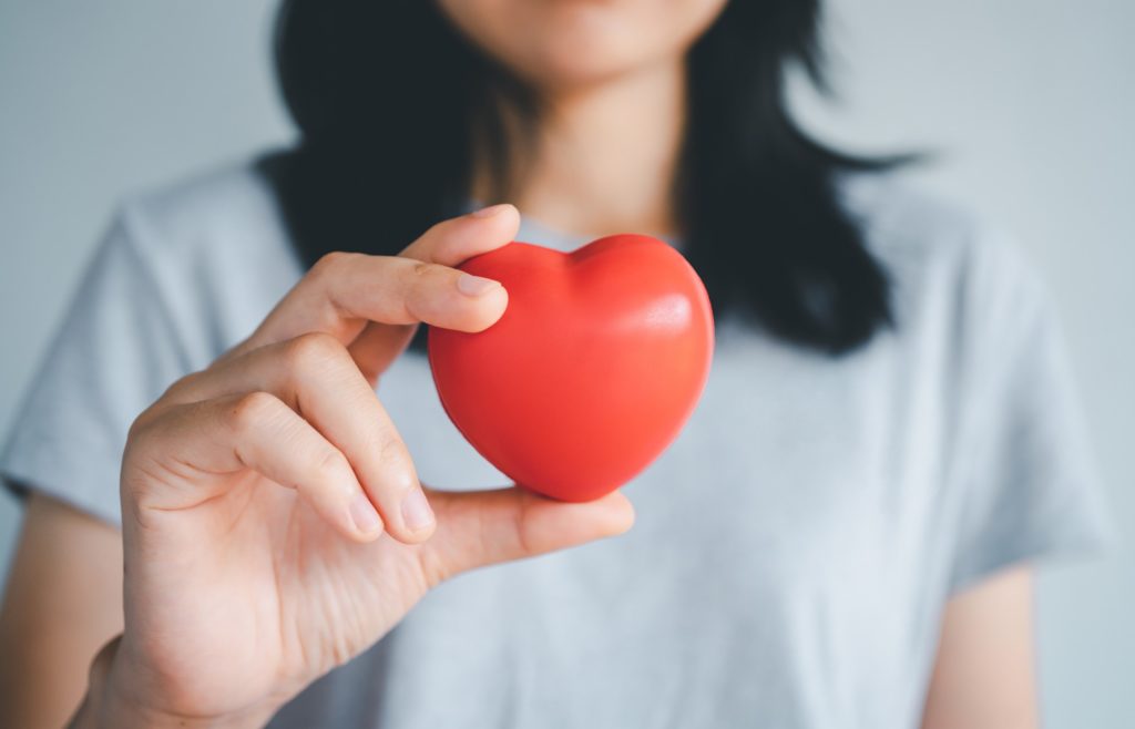 Closeup of woman holding a prop heart