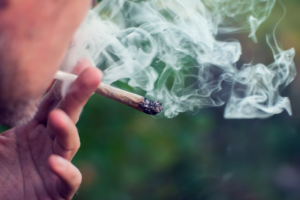 a man smoking marijuana